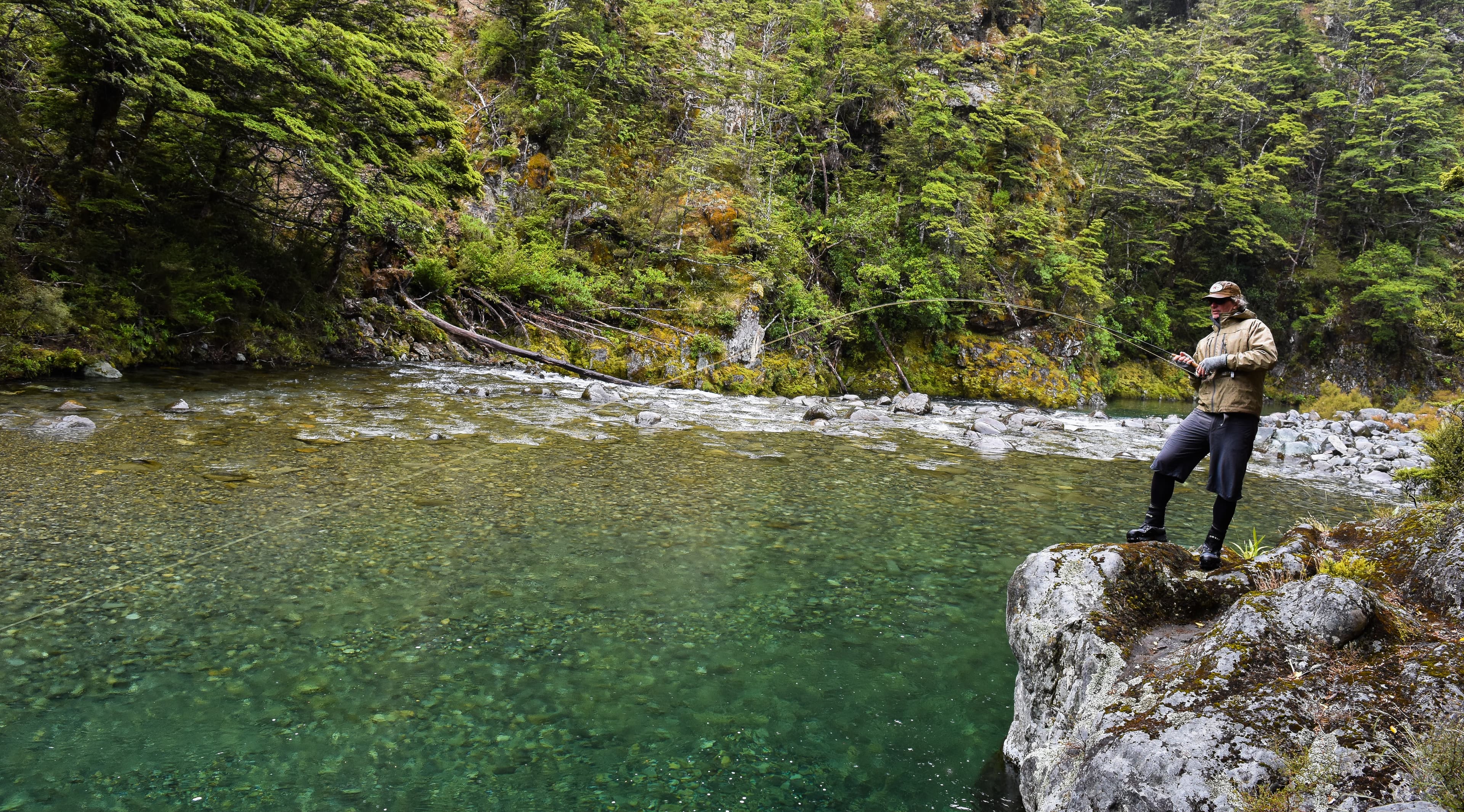 Man fly fishing a beautiful pool on the Mohaka River catching a trout